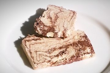 Two slices of Halvas Drapetsonas with chocolate and almonds