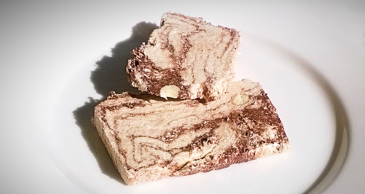 Two slices of Halvas Drapetsonas with chocolate and almonds
